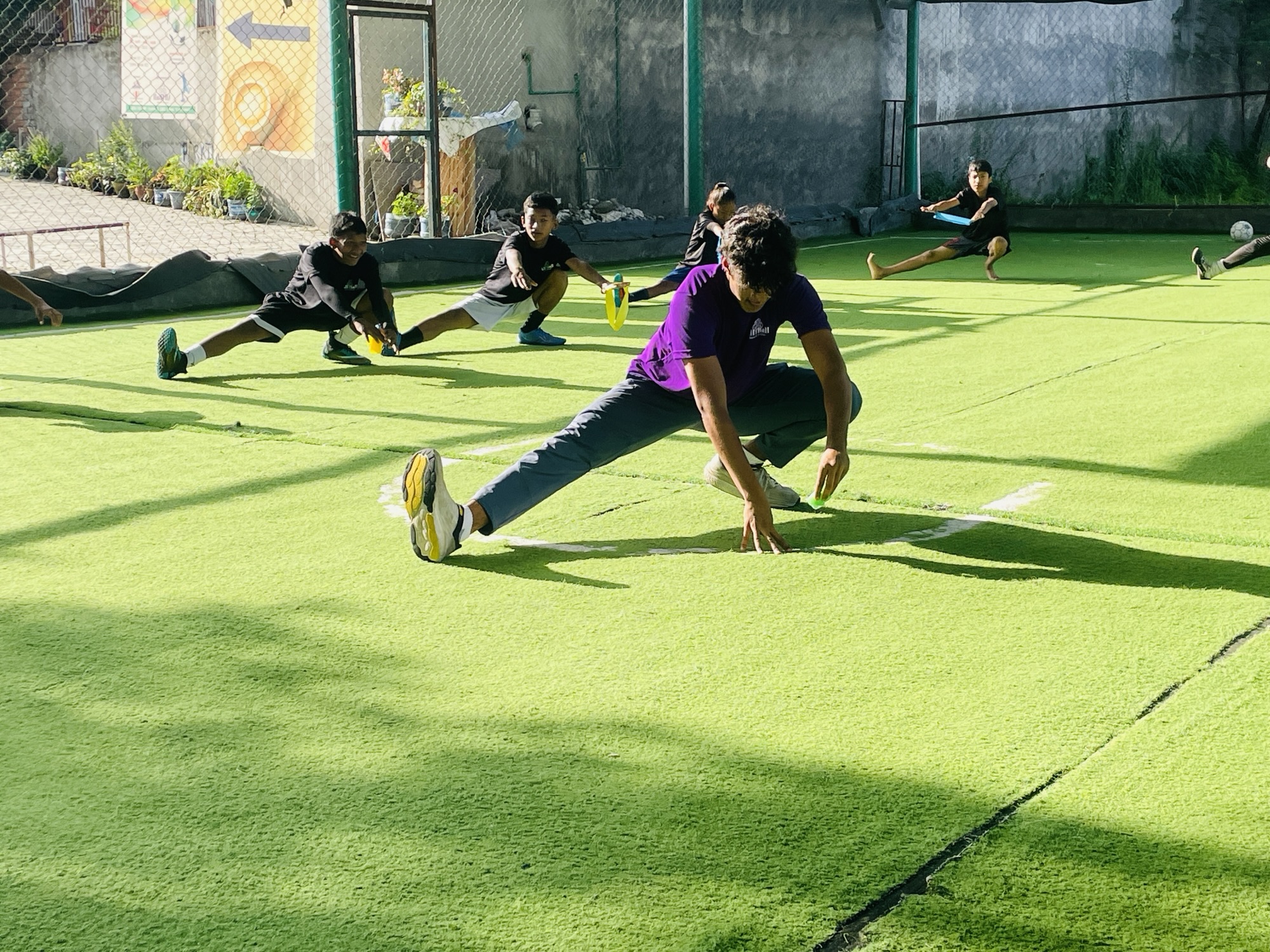 Alan Risal gets into a deep stretch leading the circle